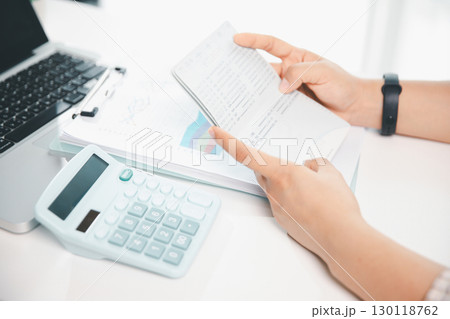 Business hands holding saving account passbook with calculator, account and saving concept. finance effectively, calculate income, track each bill and payment, accounting for bank statements and tax. Business hands holding saving account passbook with calculator, account and saving concept. finance effectively, calculate income, track each bill and payment, accounting for bank statements and tax. 130118762