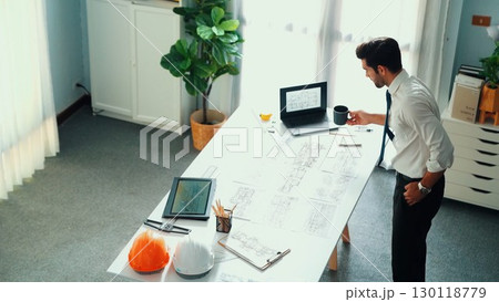 Architect engineer using laptop planning house design at office. Alimentation. 130118779