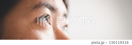 People and hope concept. Close up face female looking up feeling hope and faith. Woman praying. christianity faith, international day of prayer, female lost in thoughts feel lonely depressed pondering 130119316