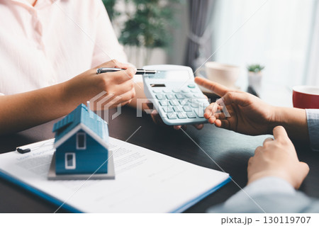 Woman real estate sale agent, client after signing agreement contract real estate with approved mortgage application form concerning mortgage loan offer, house insurance. contract agreement in office Woman real estate sale agent, client after signing agreement contract real estate with approved mortgage application form concerning mortgage loan offer, house insurance. contract agreement in office 130119707