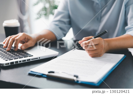 Business person with contract law and paper work for business finance, loan application form, contract real estate and insurance concept. signing contract, working on desk, business document Business person with contract law and paper work for business finance, loan application form, contract real estate and insurance concept. signing contract, working on desk, business document 130120421