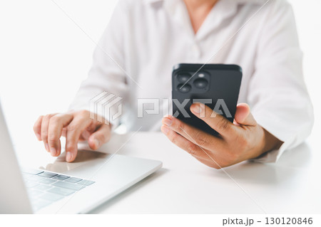 Close-up businesswoman using smart mobile phone at office table, female student is home studying online e-learning, searching for information on internet, engaging with social networks. Close-up businesswoman using smart mobile phone at office table, female student is home studying online e-learning, searching for information on internet, engaging with social networks. 130120846