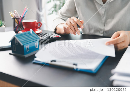 Real estate agent agree to buy home to clients agency office. House model, real estate agent, customer discussing for contract to buy house, insurance, loan real estate background. Concept agreement. Real estate agent agree to buy home to clients agency office. House model, real estate agent, customer discussing for contract to buy house, insurance, loan real estate background. Concept agreement. 130120983