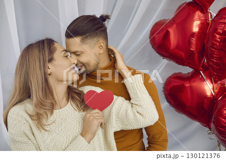 Happy young man and woman looking to each other with tenderness 130121376