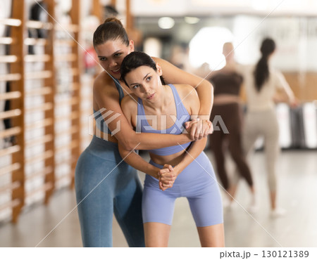 Young women in self-defense training Young women in self-defense training 130121389