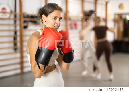 Young girl posing with boxing gloves Young girl posing with boxing gloves 130121554