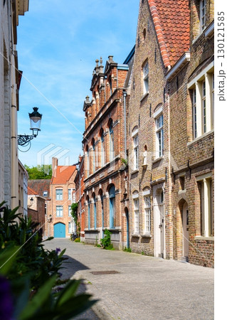 Bruges, Belgium A captivating streetscape featuring historic buildings and a clear blue sky 130121585