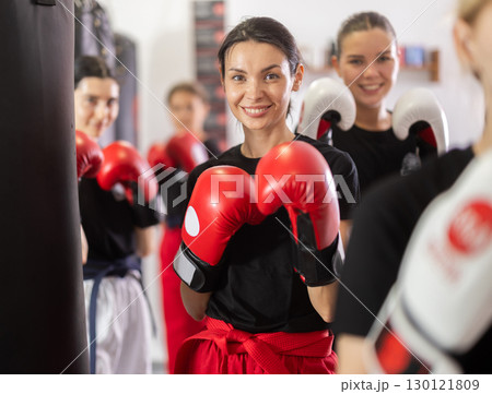Young girl posing with boxing gloves 130121809