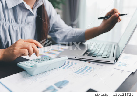 Business woman analyze calculate company financial, tax results office accounting statistics analytical research. calculating business balance prepare tax reduction. Tax deduction planning concept. 130121820