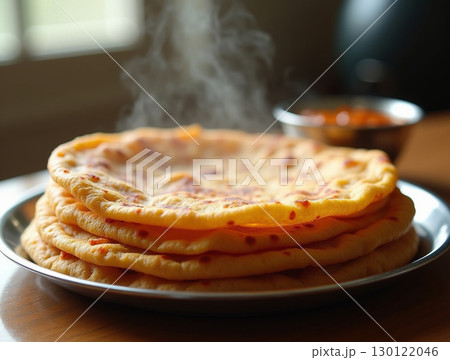 Delicious and Appetizing Aloo Paratha Indian Flatbread Served Hot with Curry Dish Delicious and Appetizing Aloo Paratha Indian Flatbread Served Hot with Curry Dish 130122046