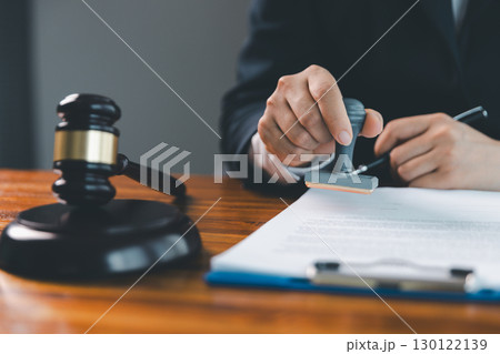 Justice and lawfirm concept. Female lawyer in office with brass scale. Woman hand gavel to bang. Law and justice trial session. Business lawyer notary stamping agreement, company secretary, validity. Justice and lawfirm concept. Female lawyer in office with brass scale. Woman hand gavel to bang. Law and justice trial session. Business lawyer notary stamping agreement, company secretary, validity. 130122139
