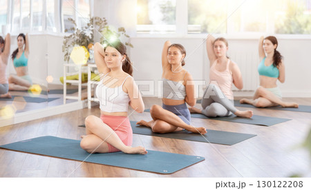 Group of women of working out practice Lord of fishes pose 130122208