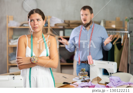 Upset seamstress scolded by colleague in workshop 130122211