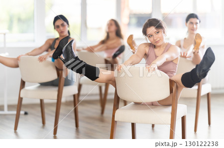 Sitting on chair, girl train to perform lap dance, interacting with imaginary partner 130122238