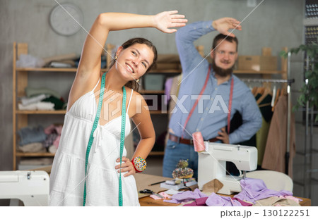 Tailors having fun and stretching during work break 130122251