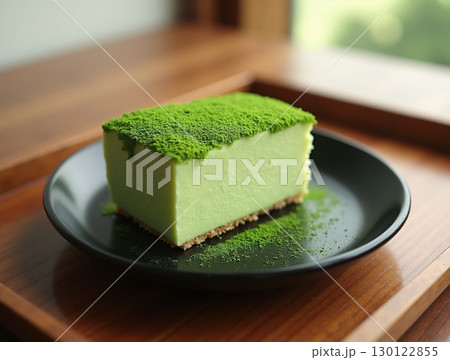 Delicious Matcha Green Tea Cheesecake Slice on a Plate Dessert Still Life 130122855