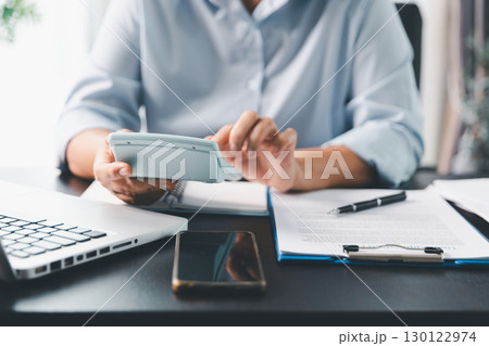 Business person with contract law and paper work for business finance, loan application form, contract real estate and insurance concept. signing contract, working on desk, business document Business person with contract law and paper work for business finance, loan application form, contract real estate and insurance concept. signing contract, working on desk, business document 130122974