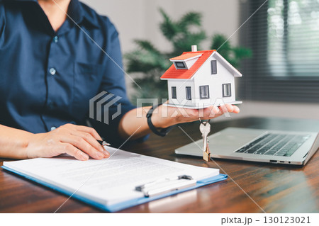 Female hand holds small miniature toy house, symbolizing woman dream of moving into her own home-real estate concept represents property investment, mortgage planning, insurance for secure future. Female hand holds small miniature toy house, symbolizing woman dream of moving into her own home-real estate concept represents property investment, mortgage planning, insurance for secure future. 130123021