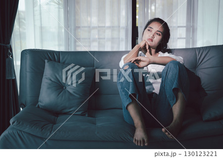Depression woman sit on sofa. Despair sorrow person sitting alone and hugging knees, Boring sad upset frustrated stressed. struggling to find hope amid suffocating burden. mental health concept. Depression woman sit on sofa. Despair sorrow person sitting alone and hugging knees, Boring sad upset frustrated stressed. struggling to find hope amid suffocating burden. mental health concept. 130123221