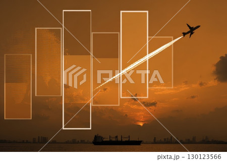 A plane is flying over a city with a sunset in the background 130123566
