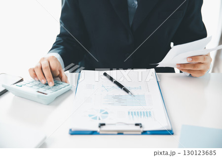 Woman calculating monthly home expenses, taxes, bank account balance and credit card bills payment, Income is not enough for expenses. financial planning, business calculate tax, investment finance. 130123685