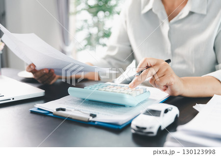 Sale agent deal to agreement successful car loan contract with customer and sign agreement contract Insurance car concept. Car dealer businesswoman signing car insurance document or lease paper. 130123998