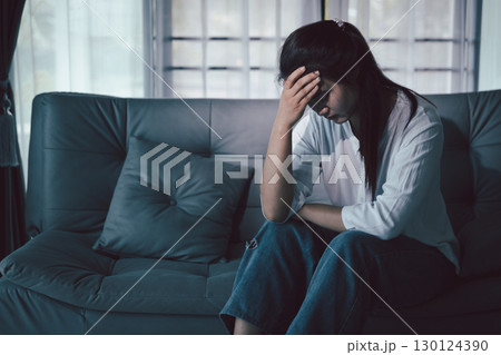 Despair sorrow person in empty dark room, Depressed young woman covering face with hands. Young woman coping with distress covering face. mental health concept. Boring sad upset frustrated stressed. Despair sorrow person in empty dark room, Depressed young woman covering face with hands. Young woman coping with distress covering face. mental health concept. Boring sad upset frustrated stressed. 130124390