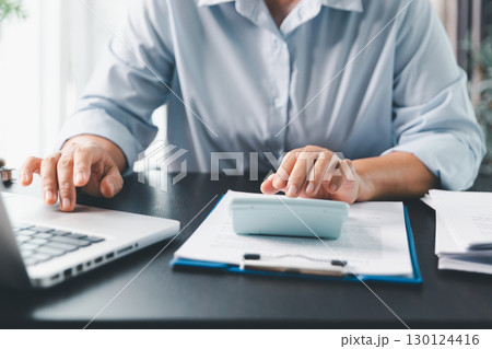 Business person with contract law and paper work for business finance, loan application form, contract real estate and insurance concept. signing contract, working on desk, business document Business person with contract law and paper work for business finance, loan application form, contract real estate and insurance concept. signing contract, working on desk, business document 130124416