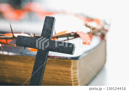 Crown of thorns and cross powerful symbols in Christianity, representing holy sacrifice of Jesus Christ in Bible and serving as enduring reminders of faith and core of Christian religion. 130124418