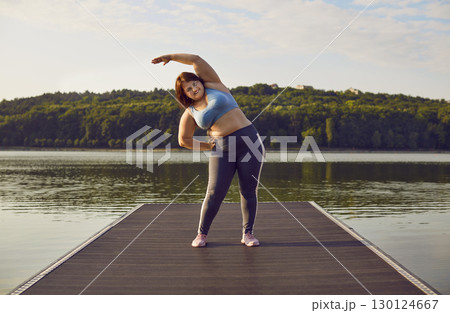 Purposeful fat woman who wants to lose weight is doing sports training outdoors. Purposeful fat woman who wants to lose weight is doing sports training outdoors. 130124667