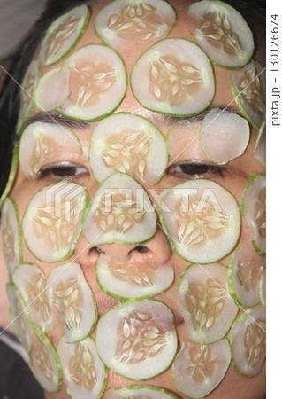 August 18, 2025. Chu Van An, Hai Phong, Viet Nam. girl beautifies facial skin with cucumber August 18, 2025. Chu Van An, Hai Phong, Viet Nam. girl beautifies facial skin with cucumber 130126674