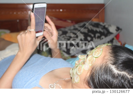 August 18, 2025. Chu Van An, Hai Phong, Viet Nam. girl beautifies facial skin with cucumber August 18, 2025. Chu Van An, Hai Phong, Viet Nam. girl beautifies facial skin with cucumber 130126677
