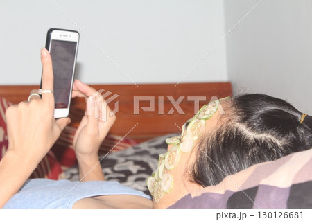 August 18, 2025. Chu Van An, Hai Phong, Viet Nam. girl beautifies facial skin with cucumber 130126681