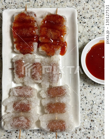 Juicy and smoky grilled sausages with a perfectly charred exterior and savory flavor. A delicious and satisfying street food favorite, perfect for any casual meal or outdoor gathering. Juicy and smoky grilled sausages with a perfectly charred exterior and savory flavor. A delicious and satisfying street food favorite, perfect for any casual meal or outdoor gathering. 130127531