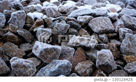 Many stones are covered with frost. Background of stones. Many stones are covered with frost. Background of stones. 130128428