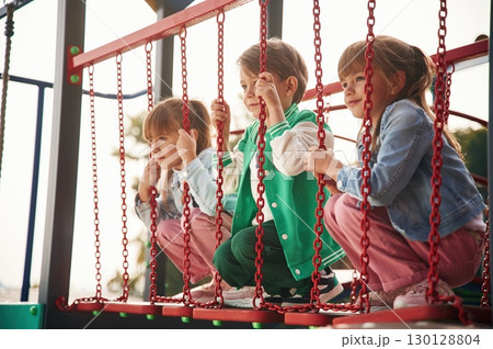 Two girl and one boy. Kids are having fun on the playground 130128804