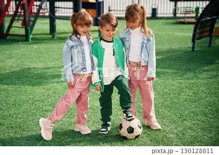 With soccer ball. Kids are having fun on the playground 130128811
