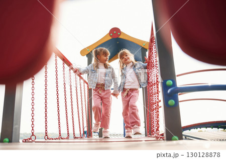 In casual clothes. Kids are having fun on the playground In casual clothes. Kids are having fun on the playground 130128878