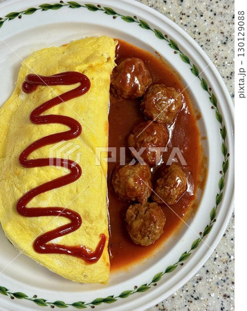 Fluffy omurice filled with savory fried rice topped with a soft omelet, paired with juicy, flavorful meatballs. A perfect combination of comfort and heartiness in every satisfying bite. 130129088