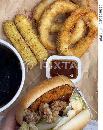 A classic combination of a juicy burger with fresh toppings served alongside golden, crispy French fries. Perfect for a satisfying meal that blends savory flavors and crunchy textures. 130129090