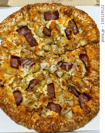 Cheesy pizza topped with golden french fries, combining crispy potato goodness with gooey, savory delight. A fun and indulgent twist on two favorite comfort foods. Cheesy pizza topped with golden french fries, combining crispy potato goodness with gooey, savory delight. A fun and indulgent twist on two favorite comfort foods. 130129122
