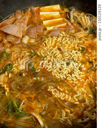 A hearty bowl of Budaejjigae (Korean Army Stew), filled with sausage, tofu, kimchi, and noodles in a spicy broth. This flavorful dish brings warmth and comfort, perfect for sharing. A hearty bowl of Budaejjigae (Korean Army Stew), filled with sausage, tofu, kimchi, and noodles in a spicy broth. This flavorful dish brings warmth and comfort, perfect for sharing. 130129129