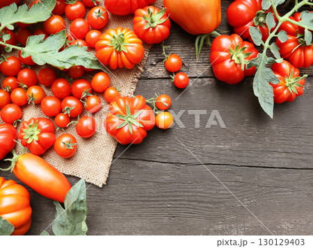 The harvest of assorted tomatoes. Variety fresh colorful tomatoes. Tomatoes different varieties The harvest of assorted tomatoes. Variety fresh colorful tomatoes. Tomatoes different varieties 130129403