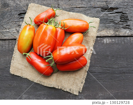 Freshly picked San Marzano tomatoes on a old wooden table	 130129728