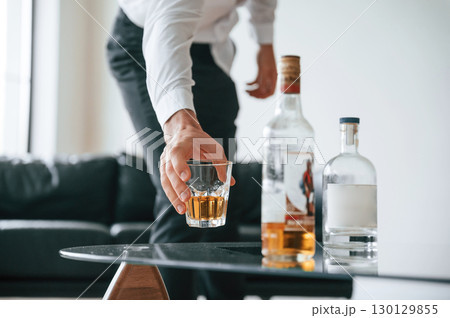 Upset young man drinker alcoholic is indoors 130129855