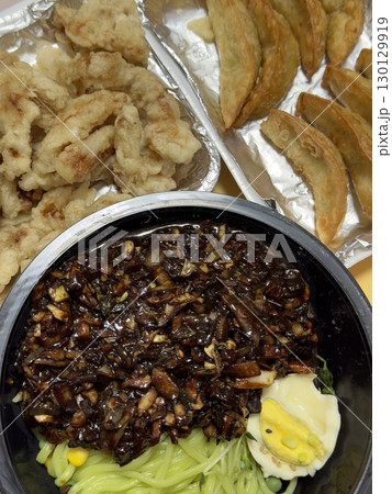 A classic Korean-Chinese combo of jajangmyeon with thick, chewy noodles coated in rich black bean sauce, served alongside crispy tangsuyuk, deep-fried pork with sweet and sour sauce. A classic Korean-Chinese combo of jajangmyeon with thick, chewy noodles coated in rich black bean sauce, served alongside crispy tangsuyuk, deep-fried pork with sweet and sour sauce. 130129919