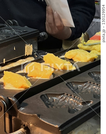 Bungeoppang, bungeo-ppang (Korean Fish Shaped Pastry), popular snack, cookies, sweet in winter streets of Korea. Bungeoppang Korean traditional national food, dish, cuisine. Japanese taiyaki Bungeoppang, bungeo-ppang (Korean Fish Shaped Pastry), popular snack, cookies, sweet in winter streets of Korea. Bungeoppang Korean traditional national food, dish, cuisine. Japanese taiyaki 130129954