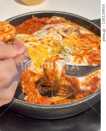 Classic spaghetti coated in rich tomato sauce, offering a simple yet delicious combination of tangy, savory flavors perfect for a comforting meal. 130129959