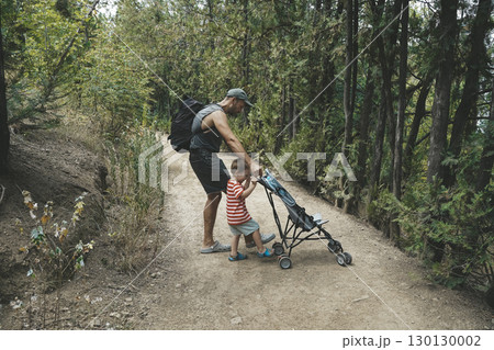 Father and Toddler Spending Time in Summer Forest Father and Toddler Spending Time in Summer Forest 130130002