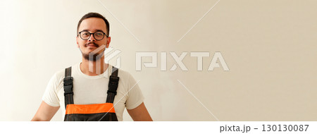 portrait of a construction worker in his overall, with a focus on his professional and an elegant design and plenty of copy space. professional electrician portrait copy space portrait of a construction worker in his overall, with a focus on his professional and an elegant design and plenty of copy space. professional electrician portrait copy space 130130087